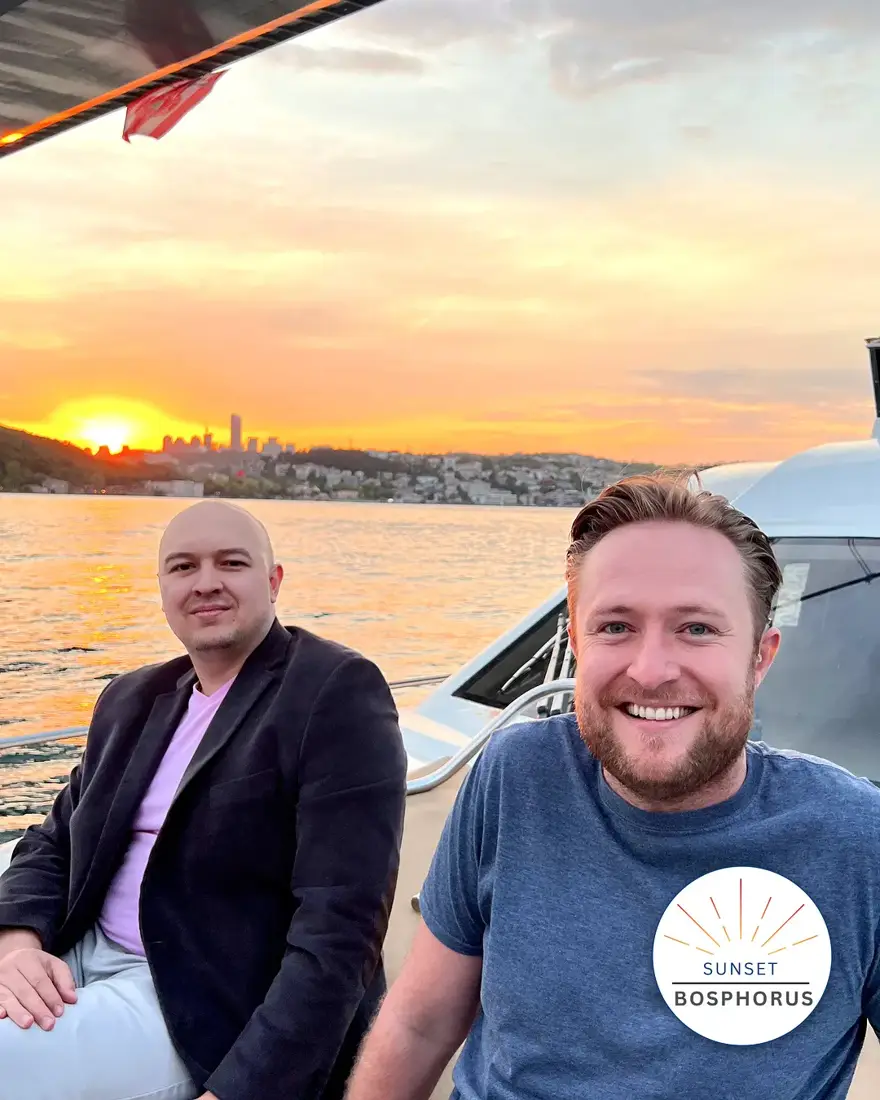 A Bosphorus sunset cruise boat pulling away from Karaköy, Galata Tower on the skyline