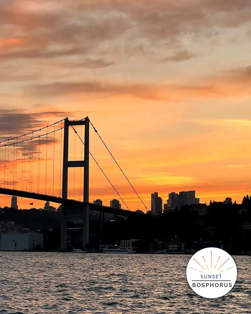 Ortaköy Mosque lit at dusk beneath the first Bosphorus bridge
